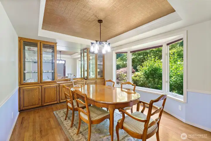 Coffered ceilings and built-in display hutch with accent lights.