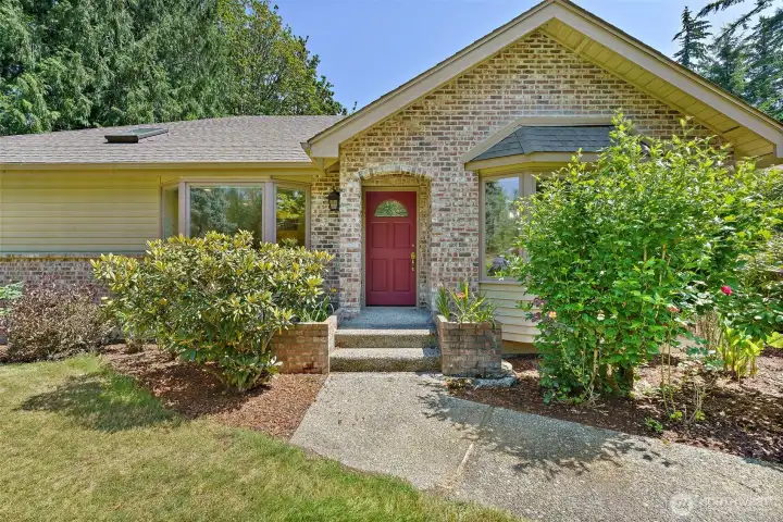 Front entry with brick and clear cedar siding.