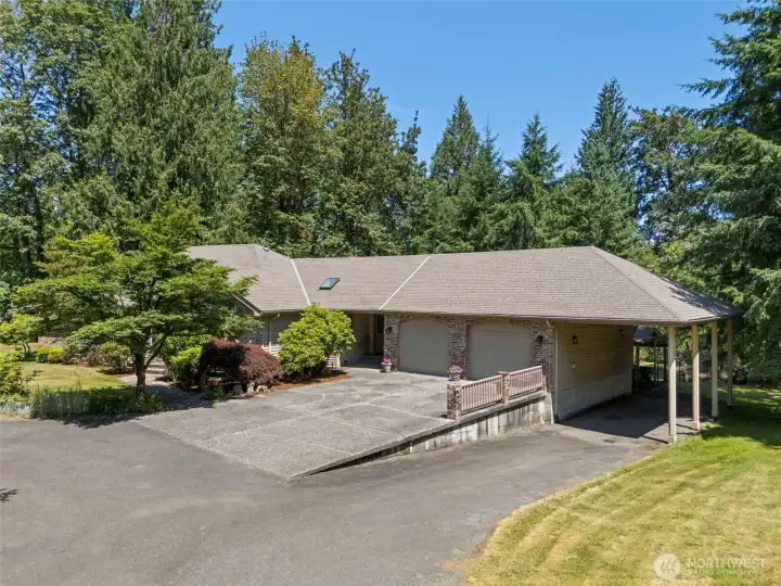 Oversized 2 car garage with RV carport.