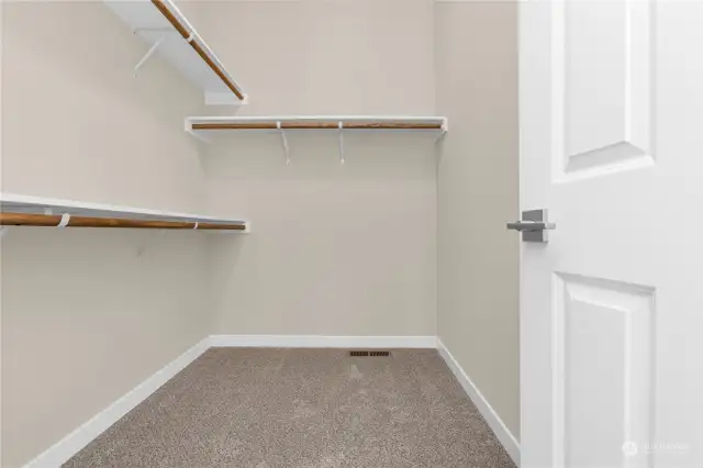 Primary closet. Photo from same plan on different lot, finishes and features will vary.