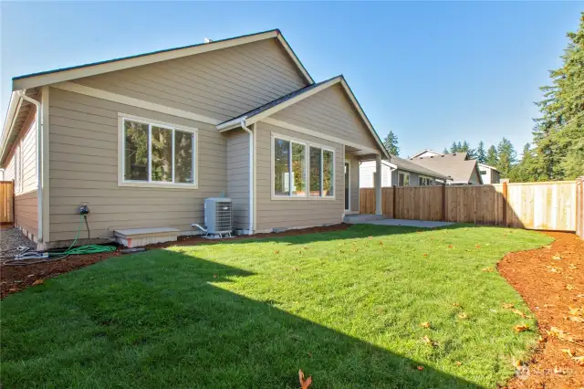 Backyard is fully fenced and landscaped with a patio and covered porch.Photo from same plan on different lot, finishes and features will vary.
