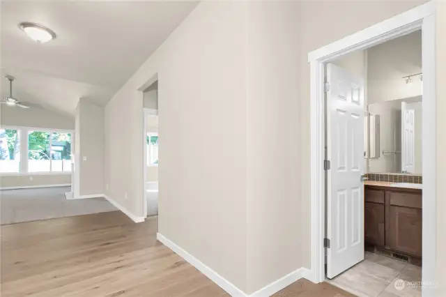 Entry hall extends to the great room and includes a full bath for convenient access. Photo from same plan on different lot, finishes and features will vary.