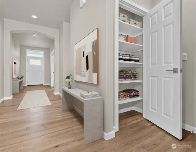 Entry hall provides premium wall space for your favorite art. The central location of the linen closet allows easy accessibility. Photo is virtually staged for reference only.