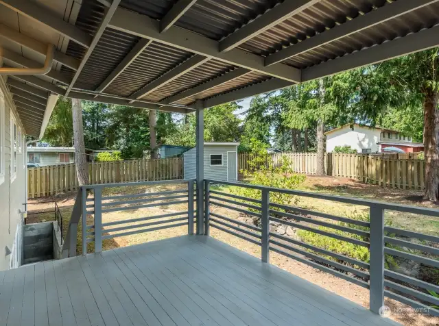 Large cedar deck is covered for year round enjoyment.