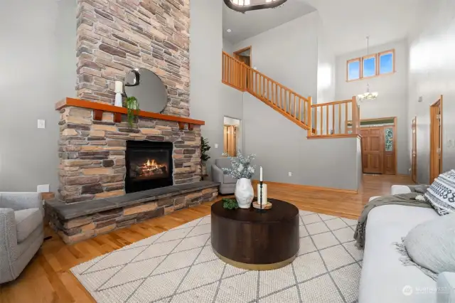 Striking stone fireplace in two story living room. Hardwood floors throughout main level.