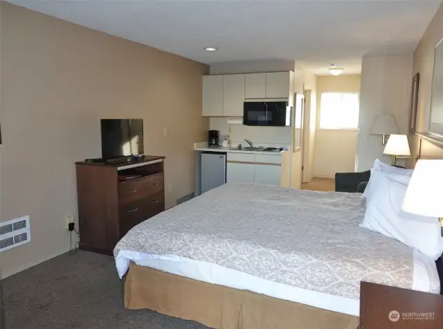 Studio Hotel Condo w/ 1 king-sized bed and kitchenette.