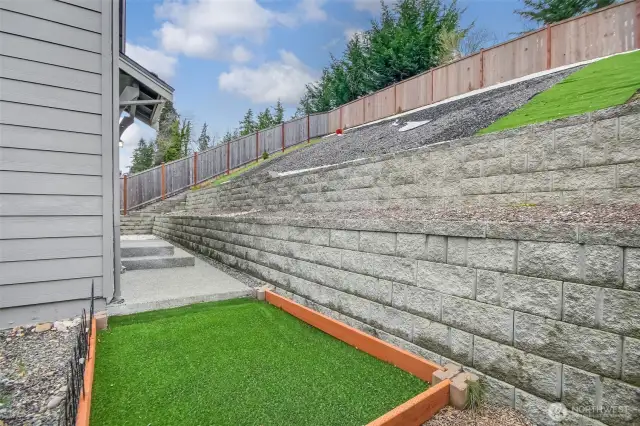 Side yard perfect for an herb garden or dog run.