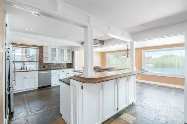 Huge kitchen with large windows to soak in the sunlight. Spacious kitchen and dining with copper raised bar and lots of space for entertaining.