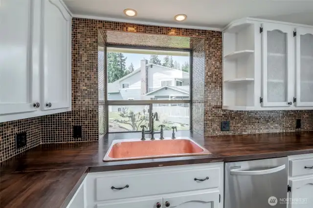 Sun window and copper sink, full height tile splash, and stainless steal appliances