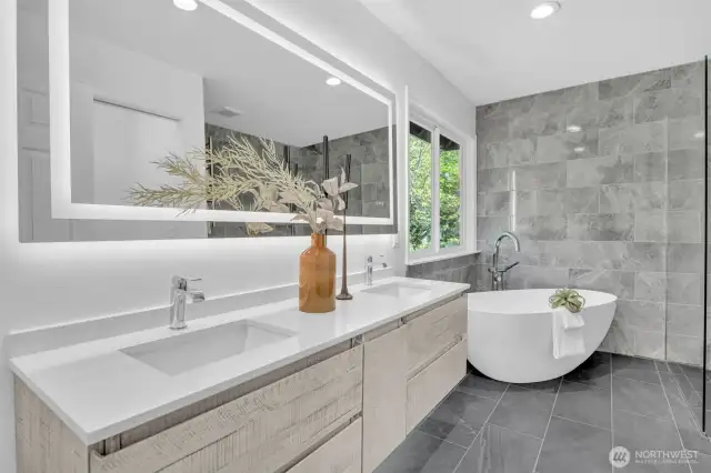 State-of-the-art remodel for this generously sized primary bath featuring a dual vanity, a stand-alone bathtub and an Italian shower.