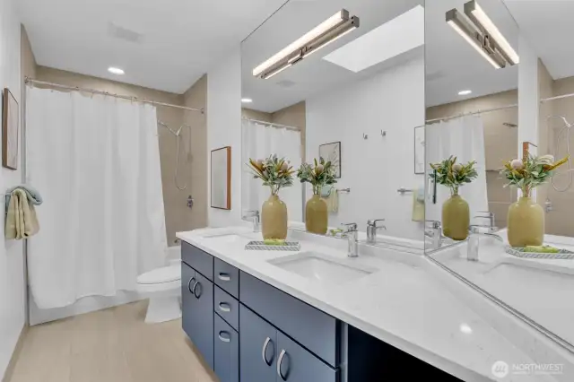 Remodeled full bathroom upstairs serving the secondary bedrooms. Thermostatic faucets in shower.