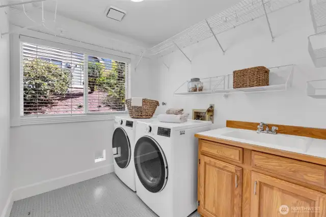 Spacious and convenient laundry room, with sink and cabinets.
