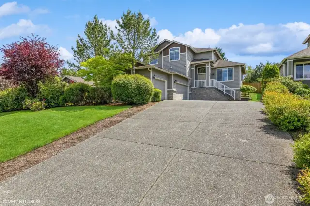 The extra-long driveway provides ample space for multiple vehicles, perfect for guests or larger gatherings.