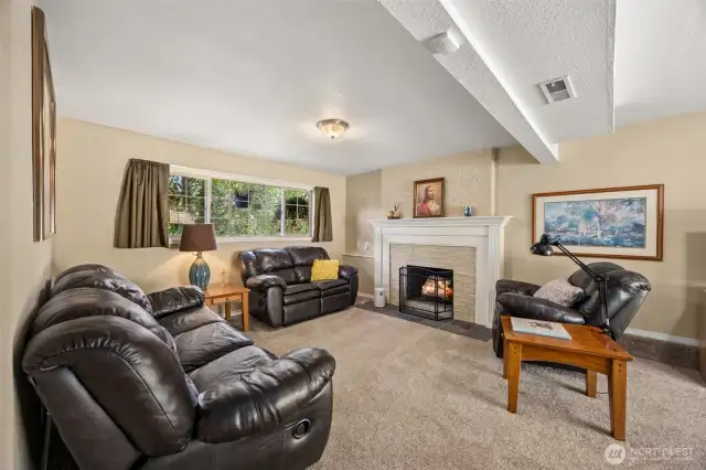 The sun-kissed lower level boasts an additional bedroom, full bath, laundry and large family room with a second fireplace and backyard access - great MIL suite potential!