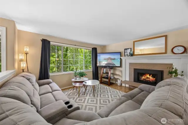 Sweeping territorial views and a spacious living room with wood laminate flooring and cozy gas fireplace.