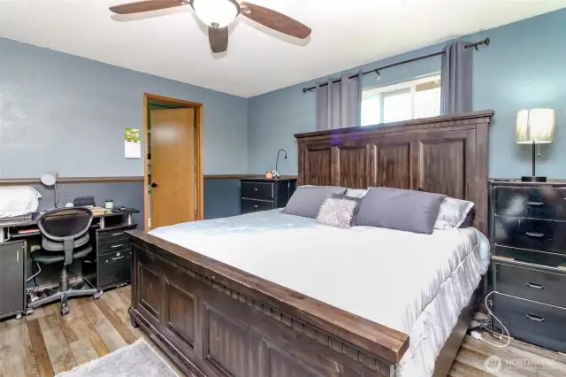 Primary bedroom with wall of closets and a private bathroom-newer flooring