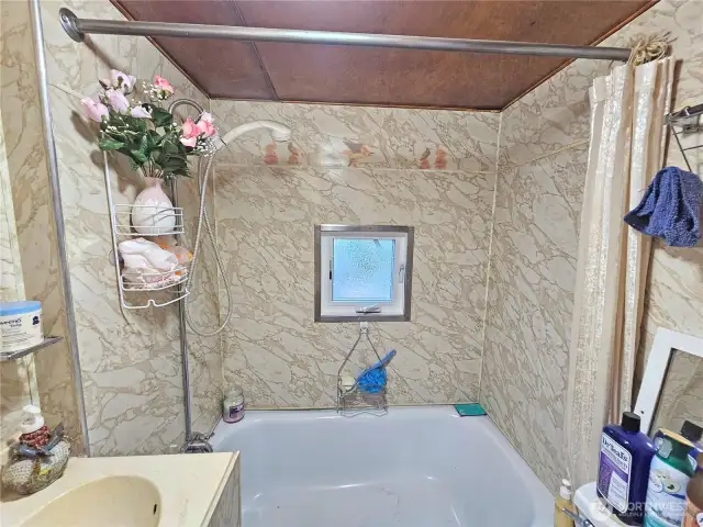 Second full bathroom with a tub and shower.