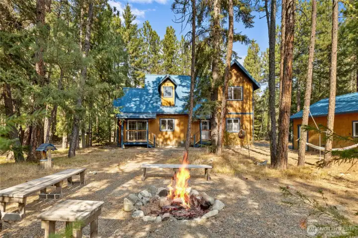 Ample sized backyard with firepit and hammock.