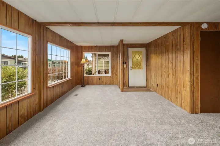 Spacious living room with big double pane windows. Lots of natural light and new carpet