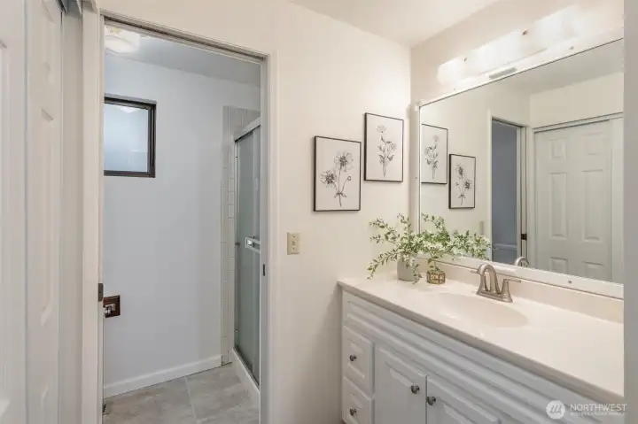 Additional closet space, updated vanity, and shower round out this space.