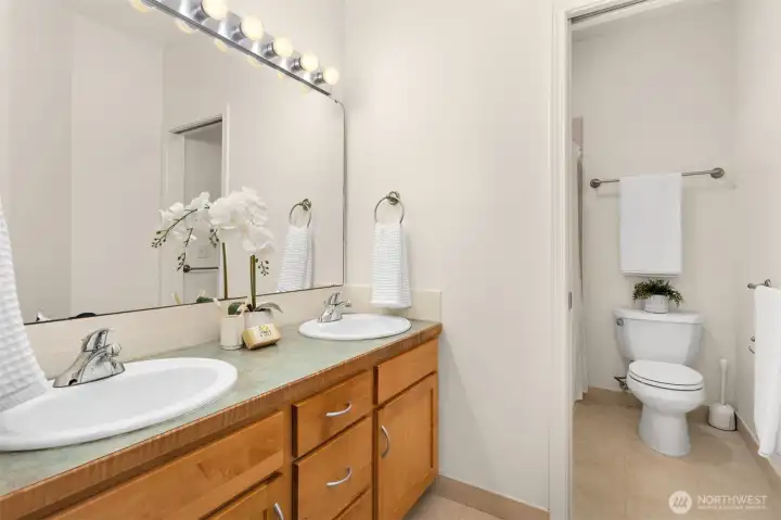 En suite bath off the primary on the main level - features a tiled walk in shower.