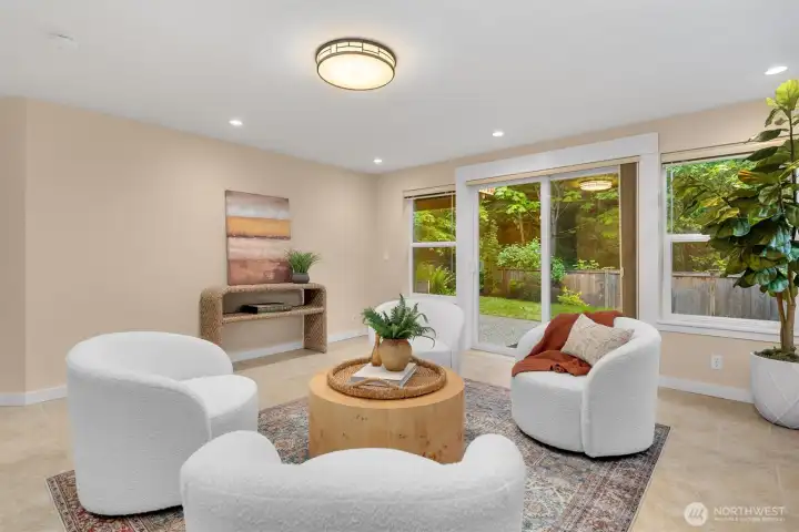 Lower level features a large second living room and sliding doors out to the patio and fenced backyard.
