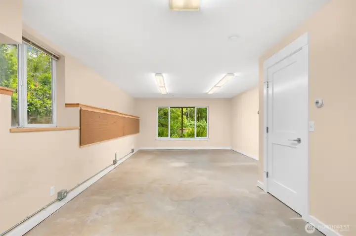 Unfinished flex space, previously used as a woodworking studio but would be a wonderful home gym, art space, or finish it off to make an additional bedroom (or two)!