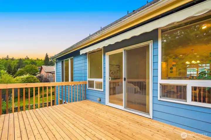 The deck was recently replaced with new cedar deck boards and railing. An awning provides shade in the summer.