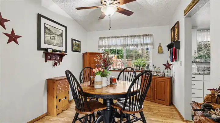 Comfortable dining space with a ceiling fan, perfect for formal meals or entertaining guests.