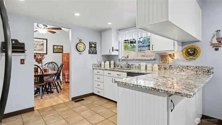 The kitchen truly serves as the heart of the home with crisp white cabinetry and ample counterspace.
