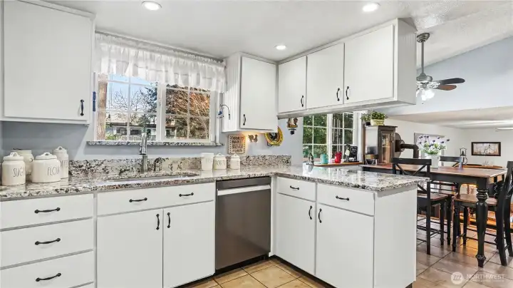 The kitchen sink sits below a window, offering a pleasant view of the backyard.