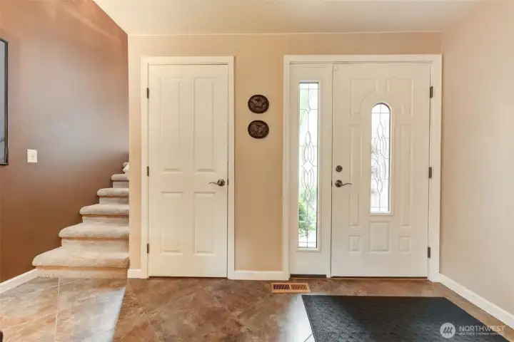 Entry way with storage closet and stairs to the second floor