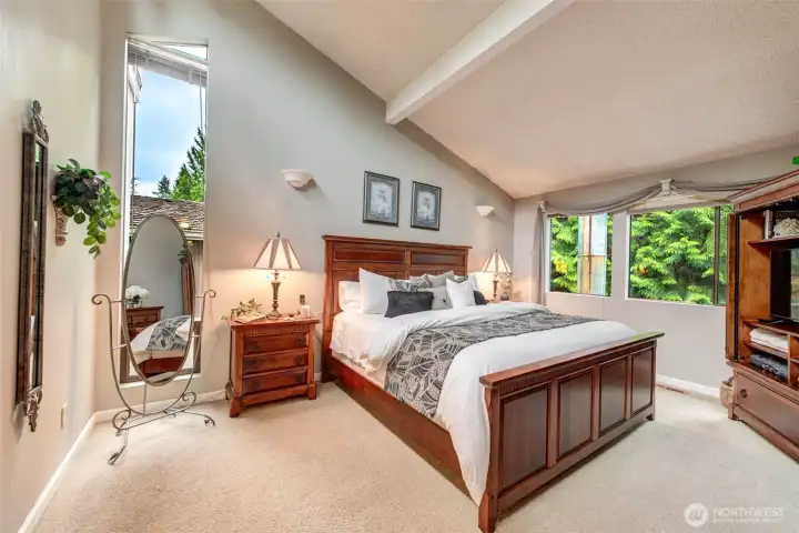 Primary bedroom with floor to ceiling window