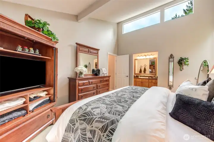 Primary bedroom with skylight and additional high windows