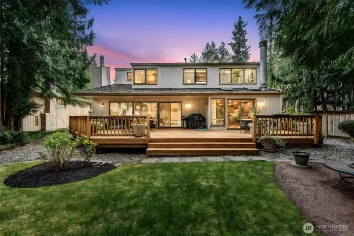 Backyard with large lawn and deck, great for entertaining