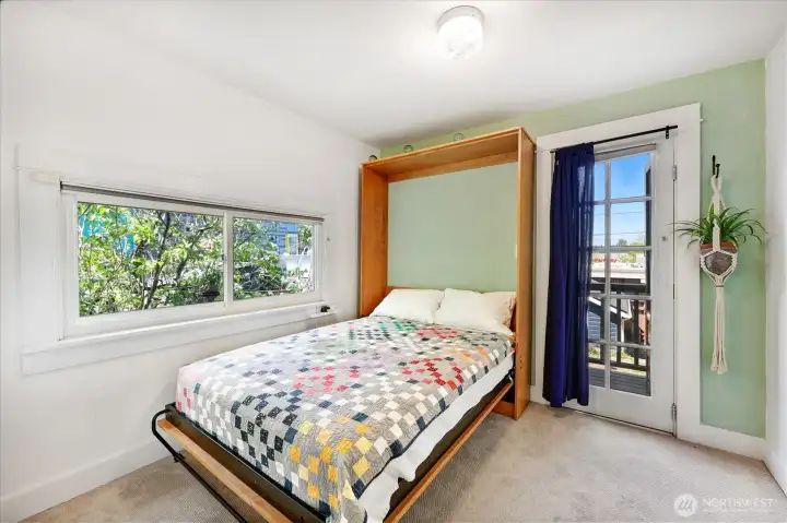 Main floor bedroom with built-in Murphy bed. Door leads to outside deck. This bedroom is non-conforming in that it doesn't have a closet.
