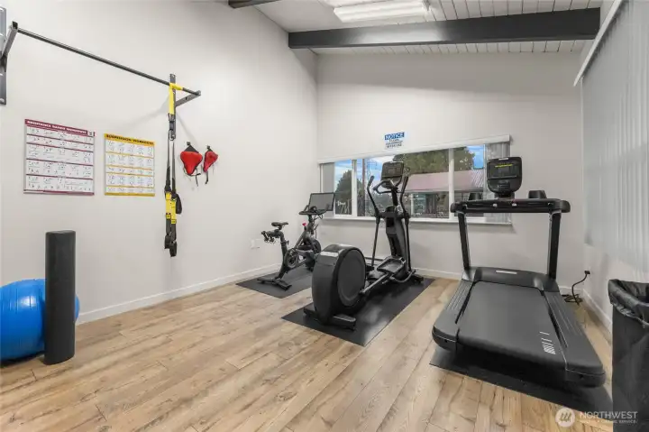 Clubhouse fitness center, equipped with free weights, treadmill, Peloton, & more!