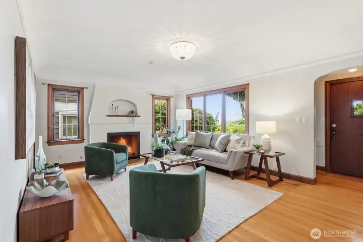 Inside, this home has everything you love about classic Seattle architecture: coved ceilings, hardwood floors, built-in shelves, a centerpiece fireplace & period lighting fixtures.