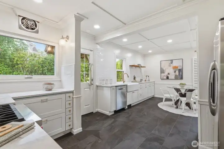 This refreshed, newly opened-up kitchen will wow cooks and guests alike! Stylish custom cabinetry, a high-end gas range, stone countertops, and plenty of space for multiple cooks.