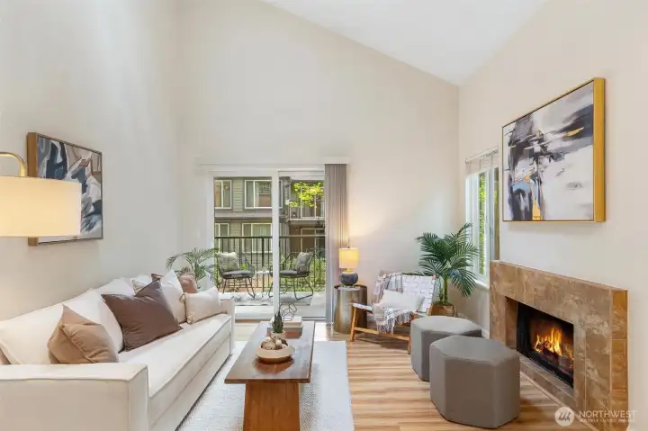 Bright living room with vaulted ceilings, fireplace, and private patio access. Bright living room with vaulted ceilings, fireplace, and private patio access.