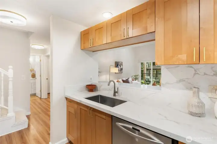 Kitchen with updated finishes and an open view to the main living area. Kitchen with updated finishes and an open view to the main living area.