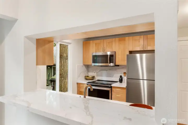 Breakfast bar overlooking the remodeled kitchen and dining space. Breakfast bar overlooking the remodeled kitchen and dining space.