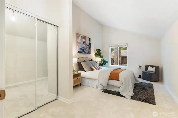 Primary bedroom featuring mirrored closet doors and generous storage. Primary bedroom featuring mirrored closet doors and generous storage.