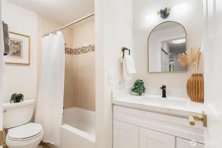 Updated full bathroom with modern vanity and tub/shower combination. Updated full bathroom with modern vanity and tub/shower combination.