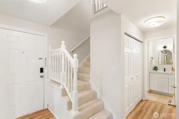 Bright entryway with staircase and upper-level hallway. Bright entryway with staircase and upper-level hallway.
