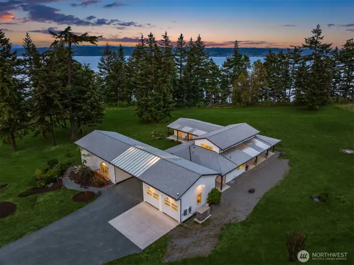 Experience timeless single-level luxury living thoughtfully designed with covered breezeways that seamlessly connect the main residence, separate studio, and entertaining spaces. This extraordinary waterfront retreat blends comfort, privacy, and architectural elegance while embracing the beauty of its surrounding landscape.