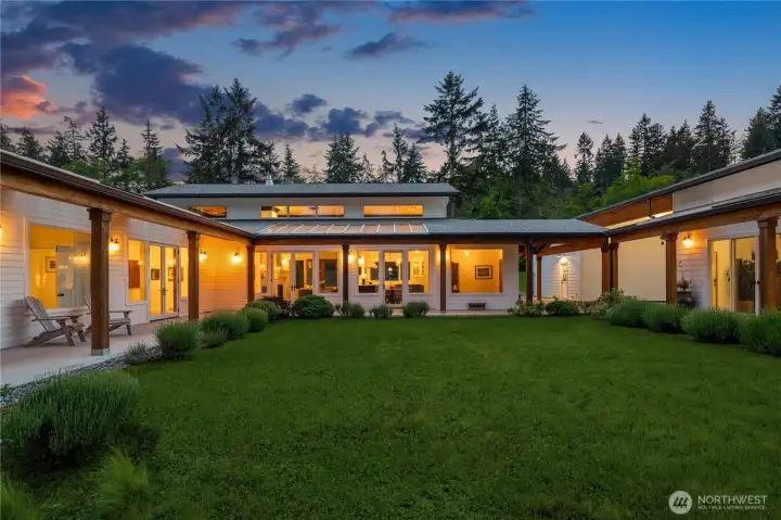 The home was thoughtfully designed around an inner courtyard where multiple doors open to covered entertaining spaces, seamlessly blending indoor and outdoor living.