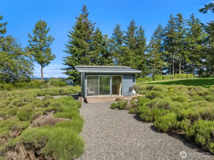Imagine the scent of fresh lavender drifting through the grounds, complemented by a charming drying shed perched at the water’s edge.