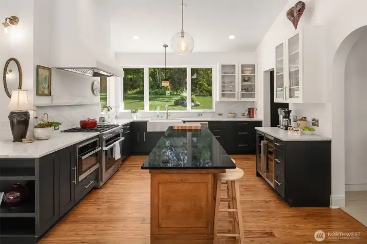 The beverage bar features a wine cooler, marble countertops, and a premium Miele appliance package.