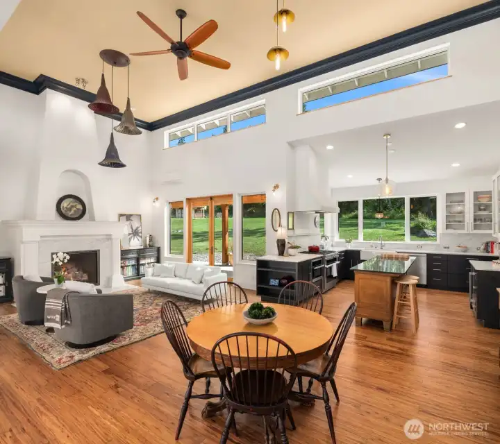 Open and expansive living spaces are thoughtfully designed for entertaining while capturing stunning water and rolling hillside views.